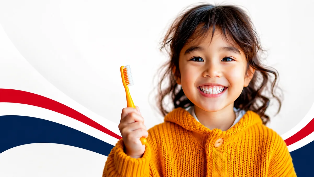 A smiling child holding a toothbrush at Five Star Dentistry